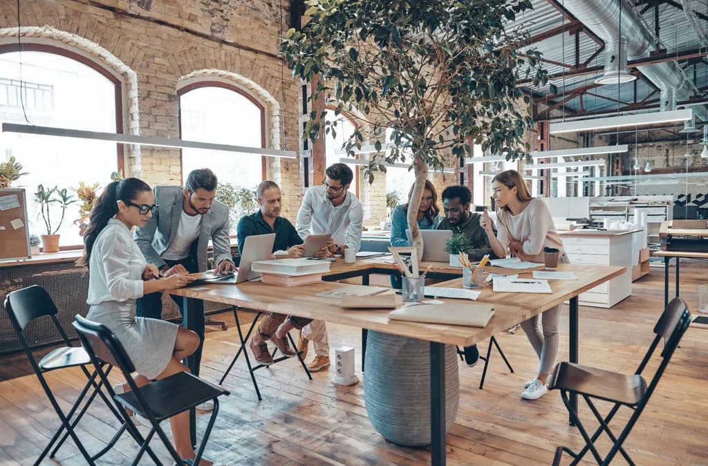 Business consultant teaching and presenting to clients in professional office setting